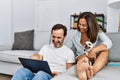 Middle age man and woman couple using laptop sitting on sofa with chihuahua at home Royalty Free Stock Photo