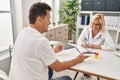 Middle age man and woman doctor and patient having medical consultation at clinic Royalty Free Stock Photo