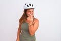 Middle age mature cyclist woman wearing safety helmet over  background Beckoning come here gesture with hand inviting Royalty Free Stock Photo