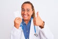 Middle age mature doctor woman showing prescription pills over isolated background happy with big smile doing ok sign, thumb up Royalty Free Stock Photo