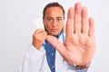 Middle age mature doctor woman showing prescription pills over isolated background with open hand doing stop sign with serious and Royalty Free Stock Photo