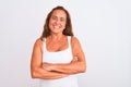 Middle age mature woman standing over white isolated background happy face smiling with crossed arms looking at the camera Royalty Free Stock Photo