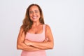 Middle age mature woman standing over white isolated background happy face smiling with crossed arms looking at the camera Royalty Free Stock Photo