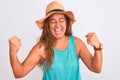 Middle age mature woman wearing summer hat over white isolated background very happy and excited doing winner gesture with arms Royalty Free Stock Photo