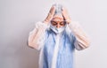 Middle age nurse woman wearing protection coronavirus equipment over white background suffering from headache desperate and