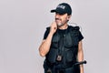 Middle age policeman wearing police uniform and bulletproof vest over white background thinking concentrated about doubt with