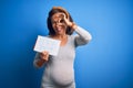 Middle Age Pregnant Woman Expecting Baby Boy Over Blue Background With Happy Face Smiling Doing Ok Sign With Hand On Eye Looking