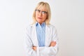 Middle age scientist woman wearing glasses standing over isolated white background skeptic and nervous, disapproving expression on Royalty Free Stock Photo