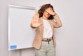 Middle age senior business woman standing on seminar presentation by magnectic blackboard covering eyes with hands and doing stop Royalty Free Stock Photo