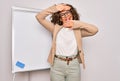 Middle age senior business woman standing on seminar presentation by magnectic blackboard Smiling cheerful playing peek a boo with Royalty Free Stock Photo