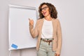 Middle age senior business woman standing on seminar presentation by magnectic blackboard smiling with happy face looking and Royalty Free Stock Photo