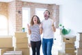 Middle age senior couple moving to a new home with boxes around crazy and mad shouting and yelling with aggressive expression and Royalty Free Stock Photo