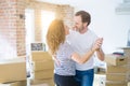 Middle age senior couple moving to a new house, dancing and smiling happy in love with apartmant Royalty Free Stock Photo