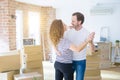 Middle age senior couple moving to a new house, dancing and smiling happy in love with apartmant Royalty Free Stock Photo