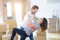 Middle age senior couple moving to a new house, dancing and smiling happy in love with apartmant Royalty Free Stock Photo