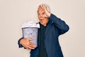 Middle age senior grey-haired business man holding paper bin full of rubbish documents with happy face smiling doing ok sign with Royalty Free Stock Photo