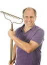 Middle age senior man holding garden bow rake tool Royalty Free Stock Photo