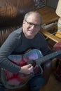 Middle age senior man playing acoustic guitar Royalty Free Stock Photo