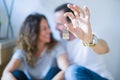 Middle age senior romantic couple in love sitting on the apartment floor with cardboard boxes around and showing house keys Royalty Free Stock Photo