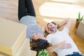 Middle age senior romantic couple lying on the floor, smiling happy for moving to a new house, relaxing and taking a break of Royalty Free Stock Photo