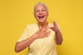 Middle age senior woman laughing at you, pointing finger to the camera. It is a great joke Royalty Free Stock Photo