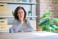 Middle age senior woman sitting at the table at home touching mouth with hand with painful expression because of toothache or Royalty Free Stock Photo