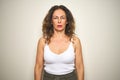 Middle age senior woman standing over white isolated background with serious expression on face Royalty Free Stock Photo