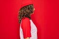 Middle age senior woman wearing baseball equiment over red isolated background looking to side, relax profile pose with natural Royalty Free Stock Photo