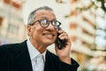 Middle age southeast asian man smiling speaking on the phone at the city Royalty Free Stock Photo
