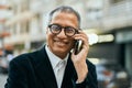 Middle age southeast asian man smiling speaking on the phone at the city Royalty Free Stock Photo