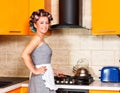 Middle-age woman with apron in the kitchen