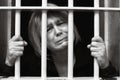 Middle Age Woman Behind Bars Royalty Free Stock Photo