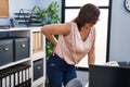 Middle age woman business worker suffering for backache at office Royalty Free Stock Photo