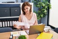 Middle age woman business worker using laptop reading document at office Royalty Free Stock Photo