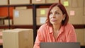 Middle age woman ecommerce business thinking at office Royalty Free Stock Photo