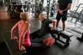 Middle age woman excercising with male friend in gym Royalty Free Stock Photo