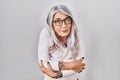 Middle age woman with grey hair standing over white background shaking and freezing for winter cold with sad and shock expression Royalty Free Stock Photo