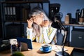 Middle age woman with grey hair working at the office at night tired rubbing nose and eyes feeling fatigue and headache Royalty Free Stock Photo