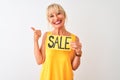 Middle age woman holding sale banner standing over isolated white background happy with big smile doing ok sign, thumb up with Royalty Free Stock Photo