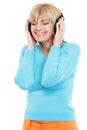 Middle age woman listening music in headphones Royalty Free Stock Photo