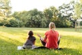 Middle age woman mother with child meditate together in park