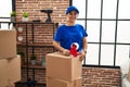 Middle age woman moving worker packing cardboard box at new home Royalty Free Stock Photo