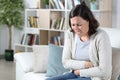 Middle age woman suffering a stomach ache at home Royalty Free Stock Photo