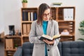 Middle age woman psychologist reading book at psychology center