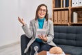 Middle age woman psychologist smiling confident speaking at psychology center Royalty Free Stock Photo