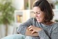 Middle age woman scratching itchy skin at home Royalty Free Stock Photo