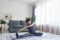 Middle age woman smiling happy doing exercise and stretching in living room at home Royalty Free Stock Photo