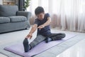 Middle age woman smiling happy doing exercise and stretching in living room at home Royalty Free Stock Photo