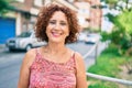 Middle age woman smiling happy walking at street of city Royalty Free Stock Photo