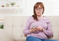 Middle age woman using smartphone at home background. Copy space and mock up. Online shopping, internet technology on cellphone. Royalty Free Stock Photo